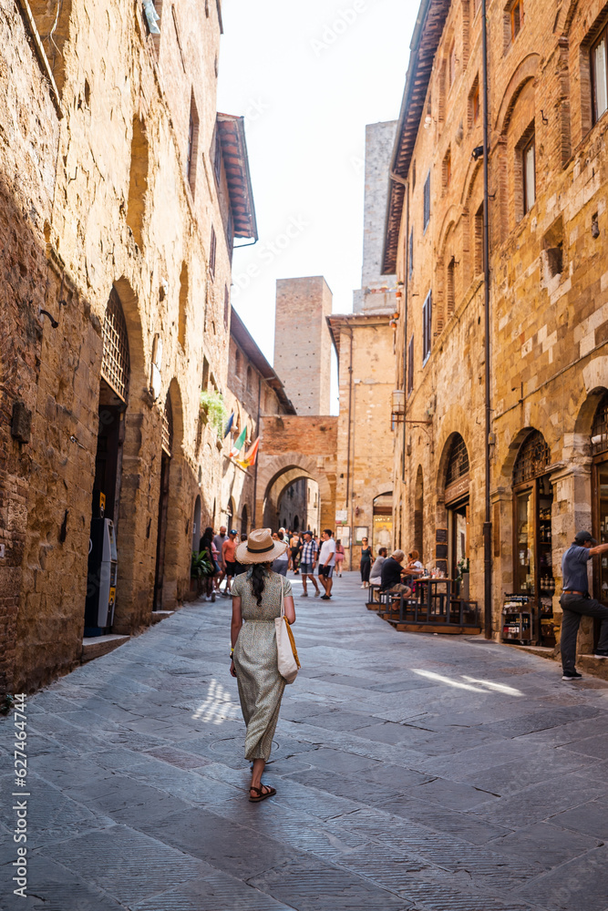 Beautiful female model on the old city streets of San Gimignano, Tuscany, Italy