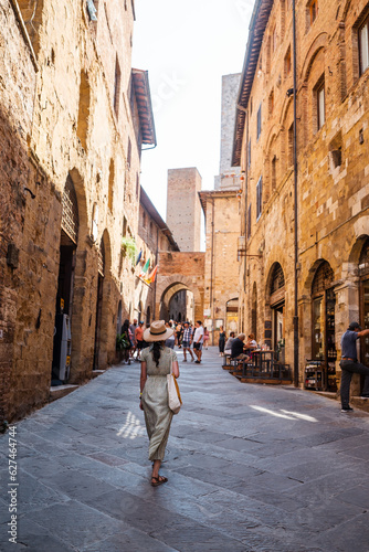 Beautiful female model on the old city streets of San Gimignano, Tuscany, Italy
