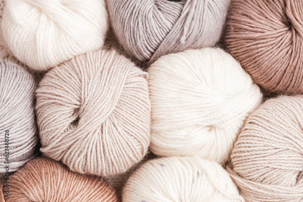Craft knitting hobby background with yarn in natural colors. Recomforting hobby to reduce stress for cold fall and winter weather. - obrazy, fototapety, plakaty 