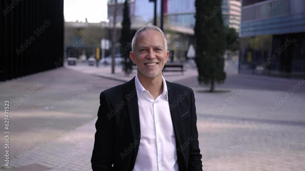 Cheerful successful mature caucasian businessman looking at camera with confidence, outdoors financial district. Cheerful successful mature caucasian businessman looking at camera with confidence, outdoors financial district.