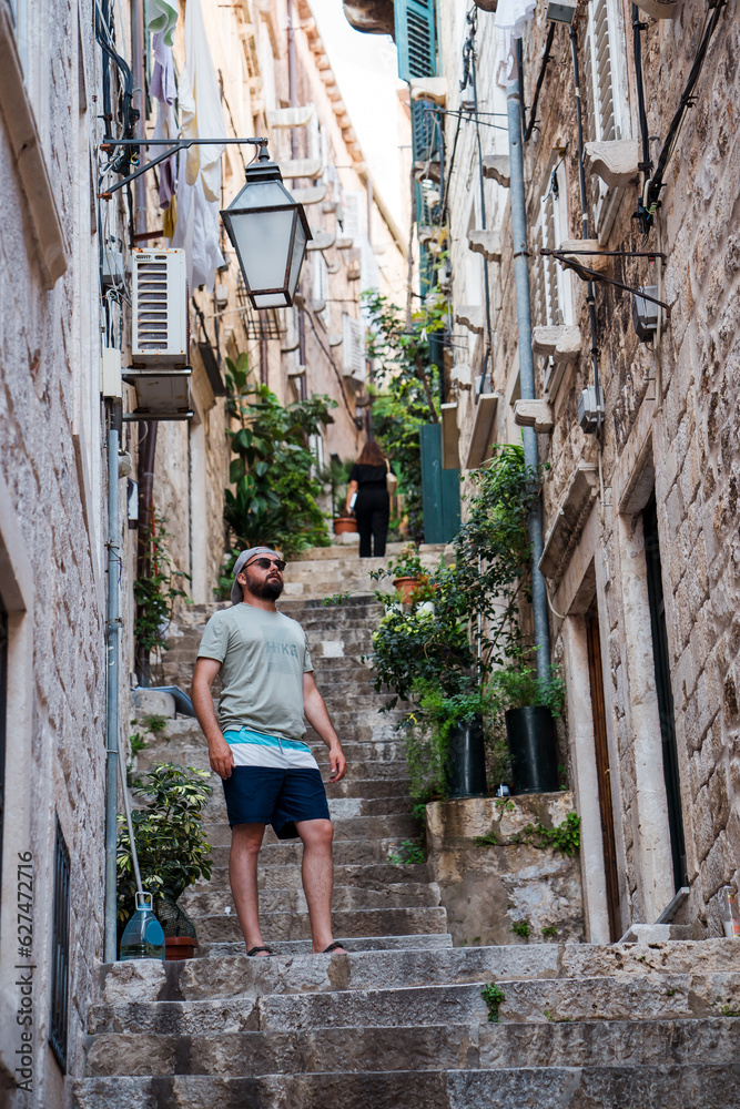 Beautiful male model on the streets of Dubrovnik. Amzing golden sunset.