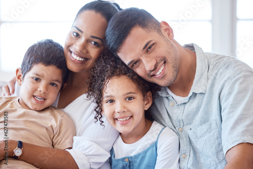 Parents, kids and portrait on couch with smile, hug and together with support, love and care in lounge. Young children, mom and dad on living room sofa for bonding, siblings and relax in family house