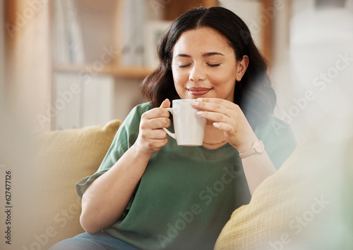 Photography Tea, relax and smile with a woman in her home, sitting on a sofa in the living room enjoying a beverage