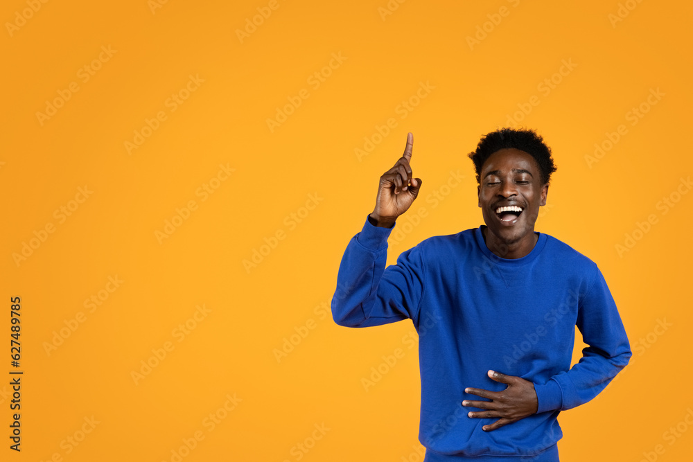 Excited young black guy pointing up, showing eureka gesture Excited young black guy pointing up, showing eureka gesture