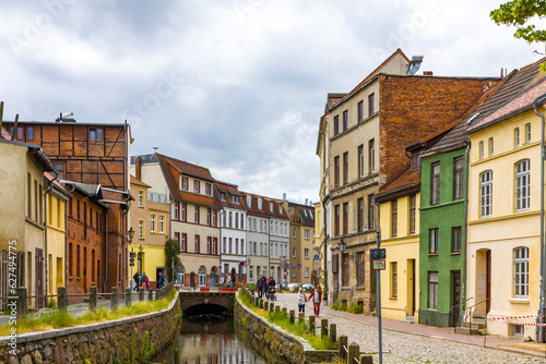 Streets of Wismar old town. Colorful houses along the canal of Grube river, Wismar city, Mecklenburg-Vorpommern state, Northern Germany