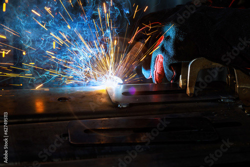 Skilled welder applies their expertise in semi automatic argon arc welding to during carry out welding works