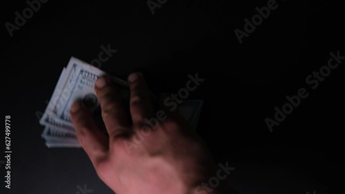 Unrecognizable Person Buying Drug from the Dealer. Bad Habits. Narcotic Concept on Black Background. Junkie Gives Money to Dealer and Gets White Drug. High Angle View of Addict and Seller Hands 4K. photo