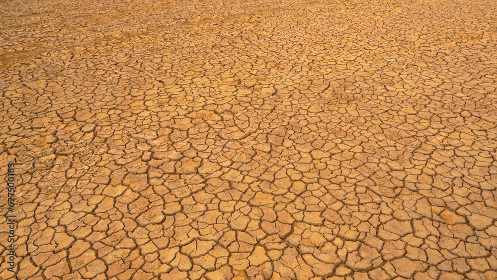 AERIAL: Pattern of cracks on a desolate desert landscape due to lack of rain AERIAL: Pattern of cracks on a desolate desert landscape due to lack of rain