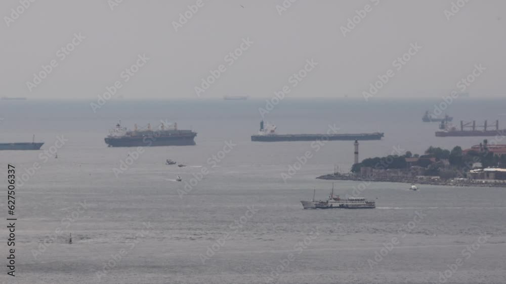 A view of the maritime traffic from the Sarayburnu offshore of the Bosphorus. While some cargo ships are waiting in line at the port, ferries continue their voyages between the European and Asian side A view of the maritime traffic from the Sarayburnu offshore of the Bosphorus. While some cargo ships are waiting in line at the port, ferries continue their voyages between the European and Asian side