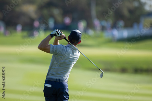 professional golf player hitting the ball. backswing