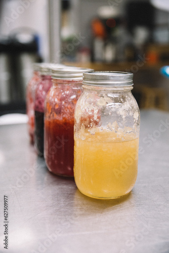 large canning jars of jam jelly in an industrial kitchen
