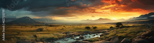 Panoramic grassland with river before a storm at dawn.