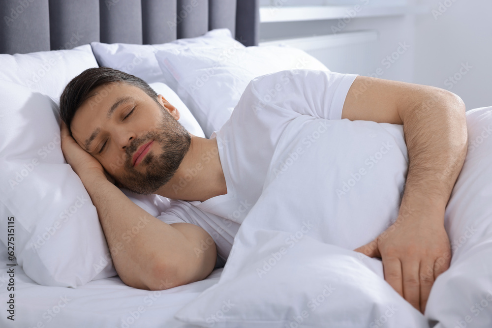 Handsome man sleeping in soft bed at home Handsome man sleeping in soft bed at home