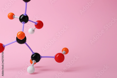 Molecule of sugar on pink background, closeup with space for text. Chemical model