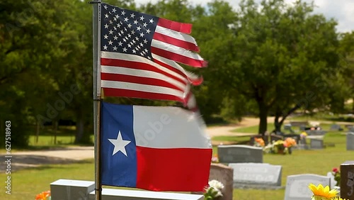 United States and Texas Flags Flying Over Cemetery in Strong Winds