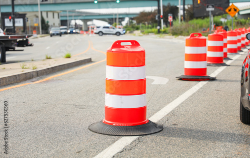 Vibrant construction cone amidst urban chaos signifies progress, safety, roadwork, caution, and temporary disruptions in the cityscape photo