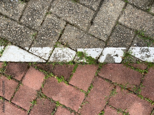 White line marking the border between grey and red floor bricks.