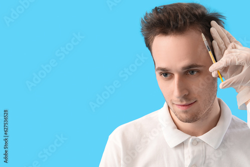 Young man receiving injecti...