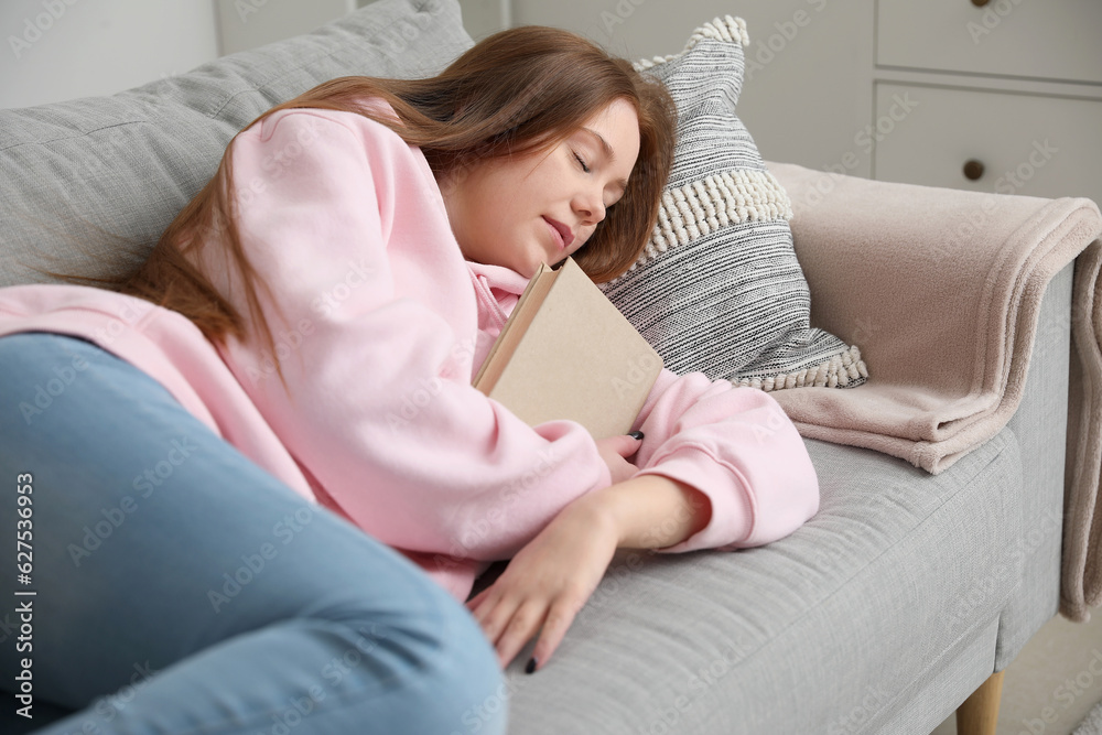 Teenage girl with book sleeping on sofa at home Teenage girl with book sleeping on sofa at home