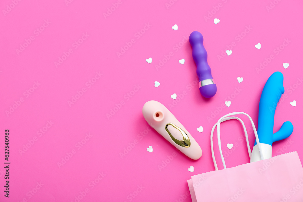 Shopping bag with vibrators and hearts on pink background Shopping bag with vibrators and hearts on pink background