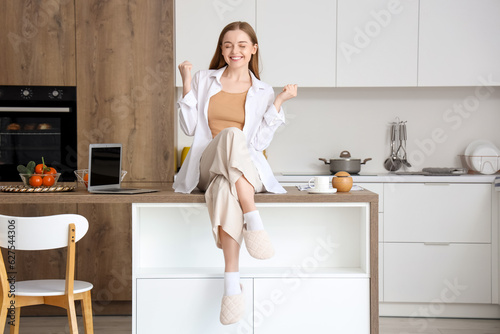 Happy young woman sitting o...