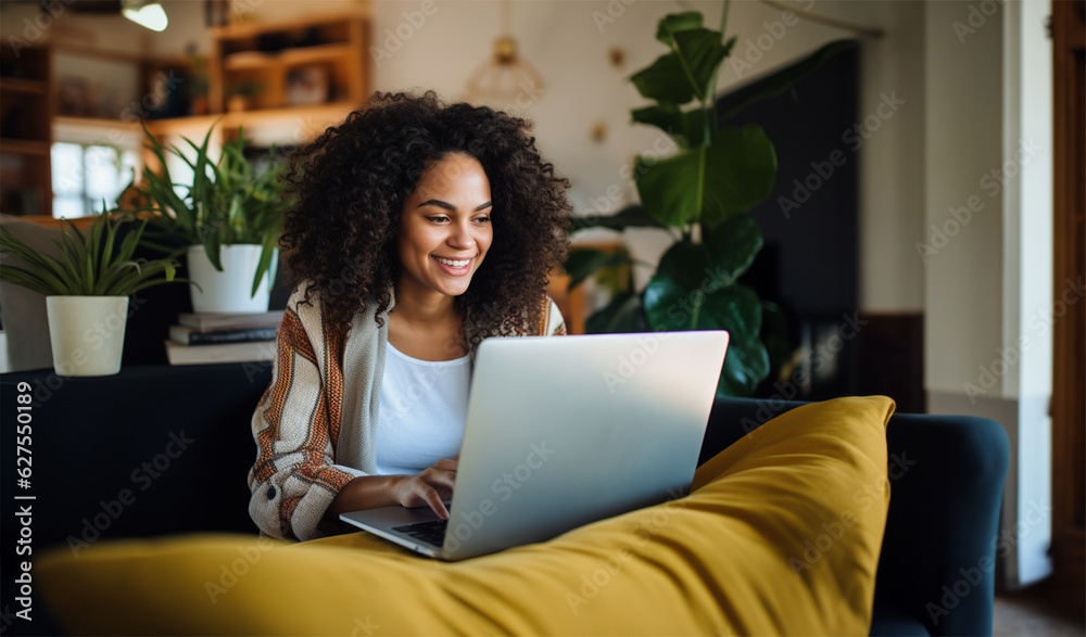 a beautiful ethnic woman working remotely on her laptop from home a beautiful ethnic woman working remotely on her laptop from home