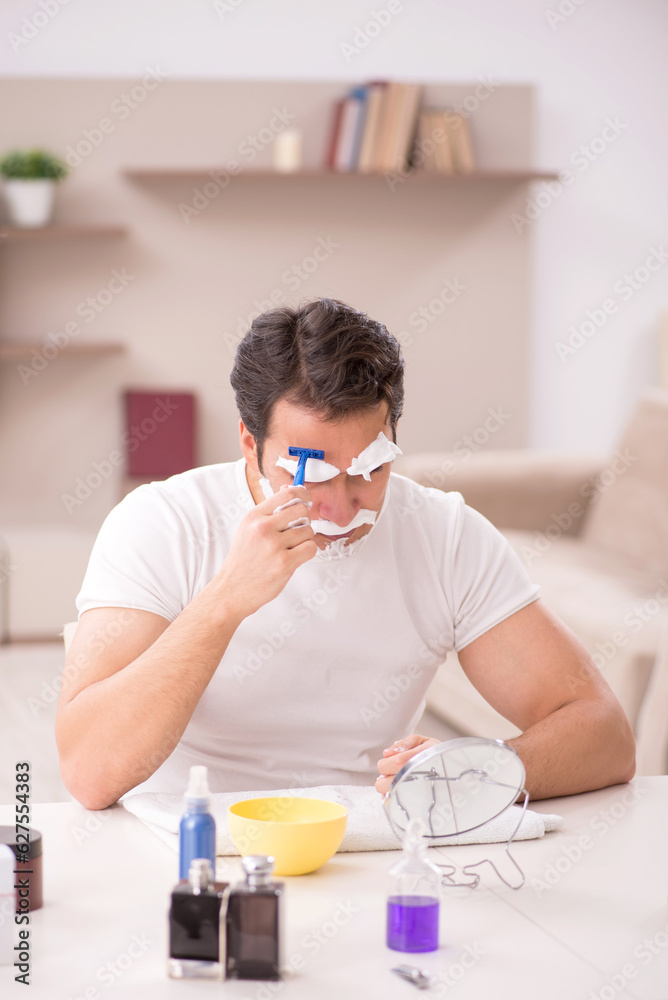 Young man shaving face at home Young man shaving face at home