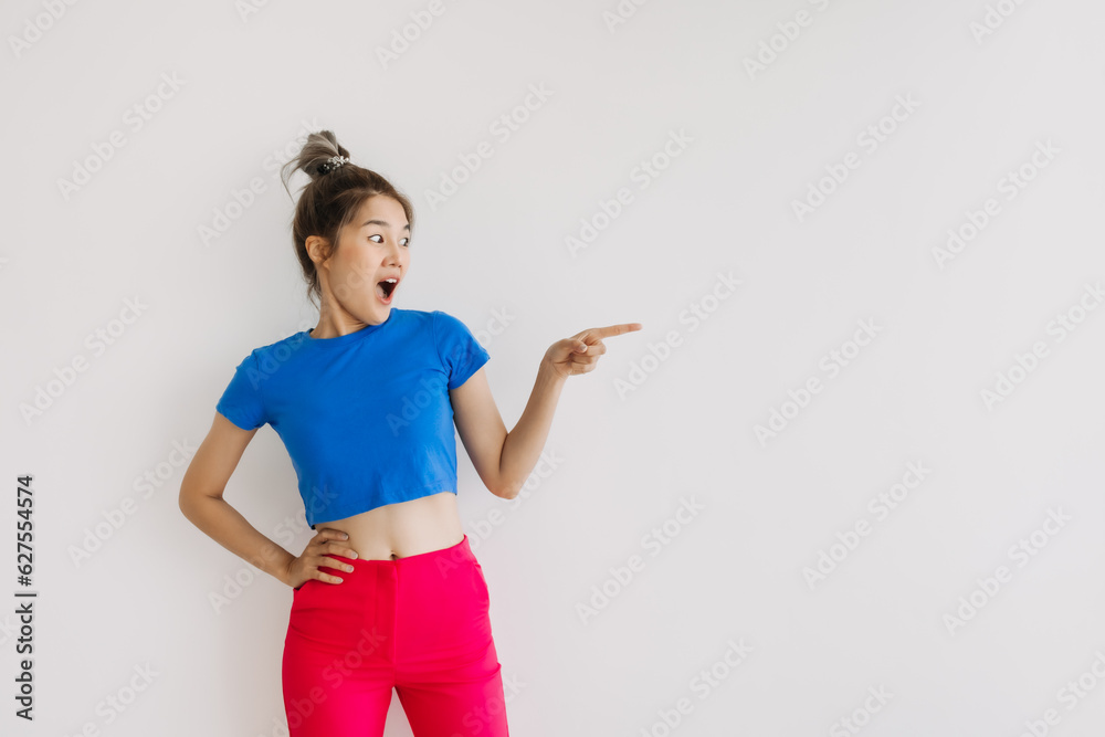 Wow and surprise face asian woman pointing at the empty space isolated on white.