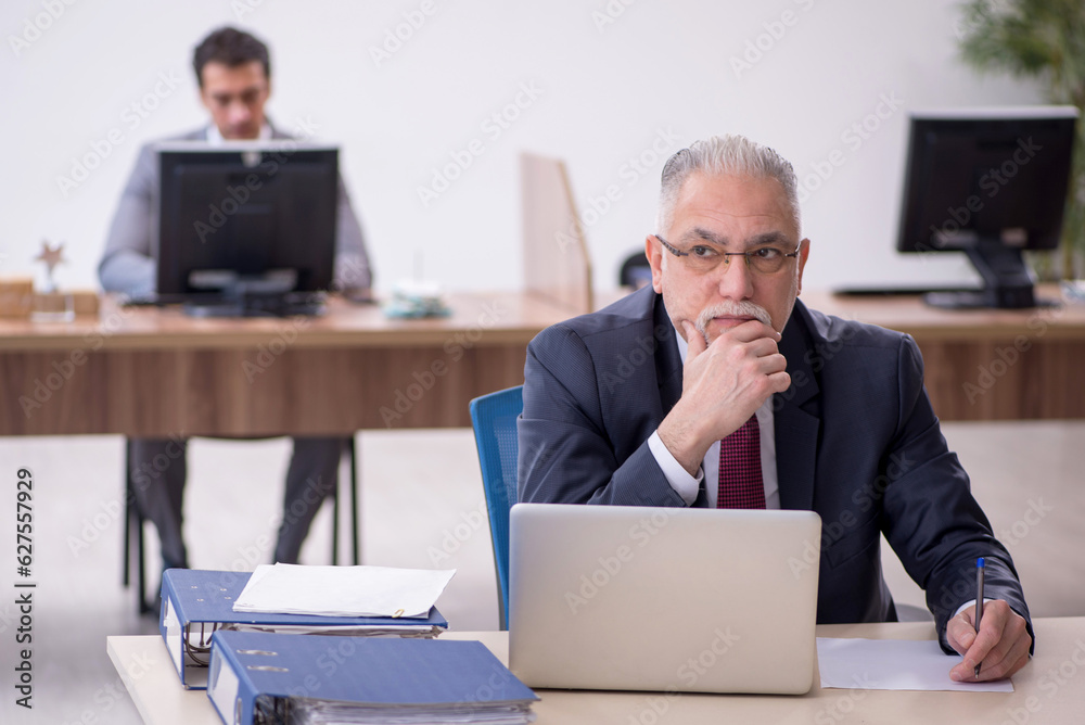 Two male colleagues working in the office Two male colleagues working in the office