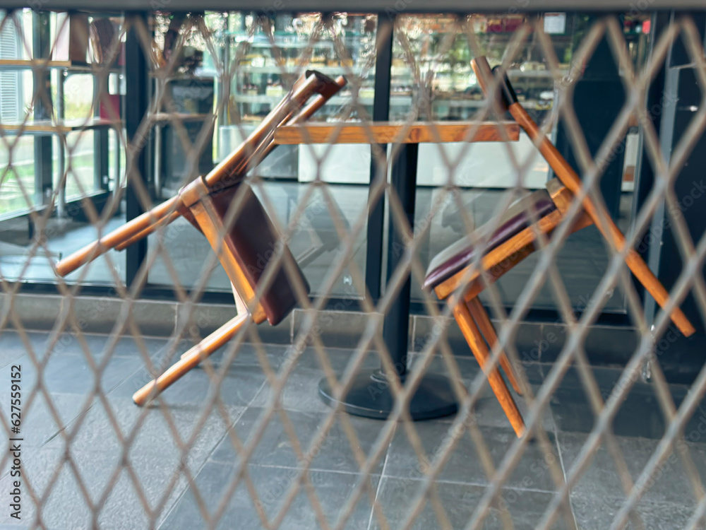 Chairs with a background of meshed iron Chairs with a background of meshed iron