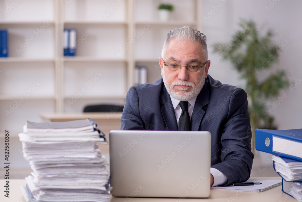 Old male employee and too much work at workplace Old male employee and too much work at workplace