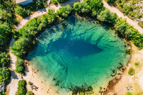 Cetina river source water hole and Orthodox church aerial view, Dalmatian Zagora region of Croatia photo