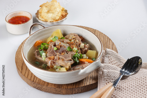 Sop Buntut or Sup Buntut is Indonesian Oxtail Soup with Carrot, Potato and Spring Onions. photo