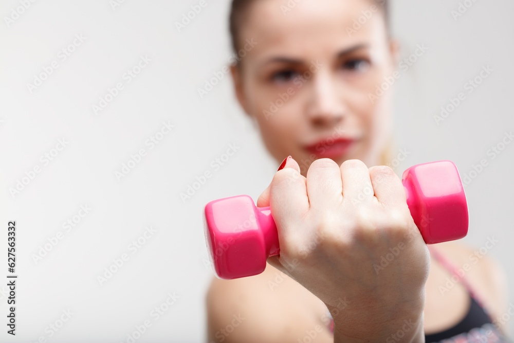 Blurred woman, pink weights, morning workout Blurred woman, pink weights, morning workout