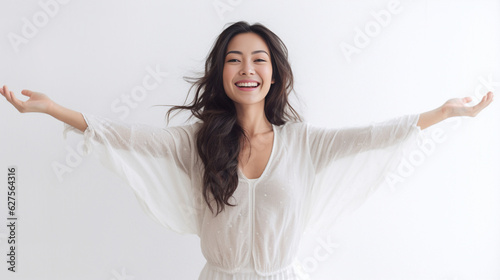 A beaming lady in a white t-shirt dress raises her arms with a relaxed smile, expressing her unbridled happiness against the pristine white backdrop. generative AI. photo
