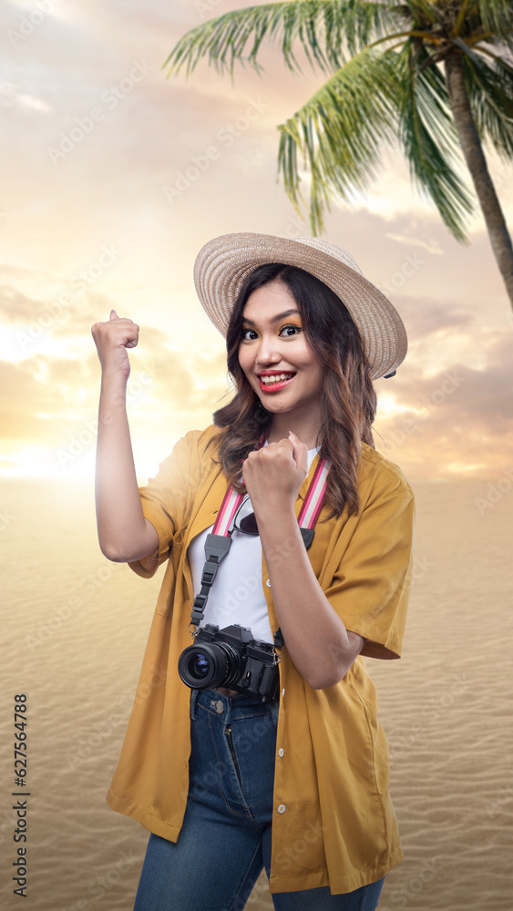Asian woman with a hat and camera with an excited expression