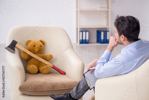 Young male psychologist meeting with toy bear