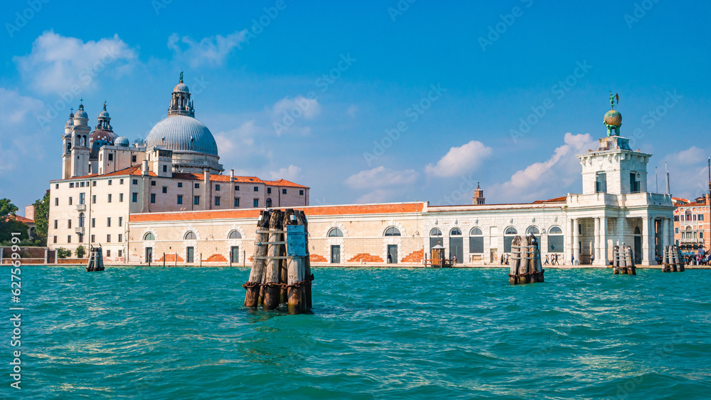 Venice, Italy. Panoramic view over Grand Canal and Basilica di Santa Maria della Salute and the historical center at sunny day and blue sky.