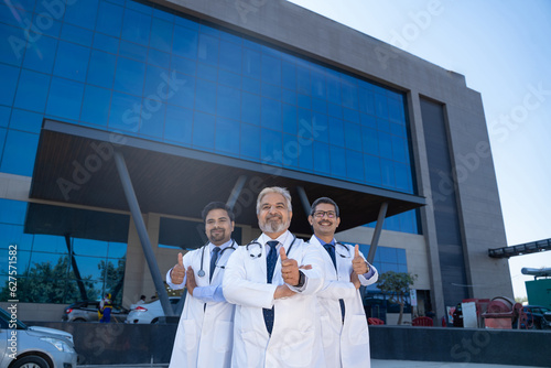 Successful team of medical doctors showing thumps up