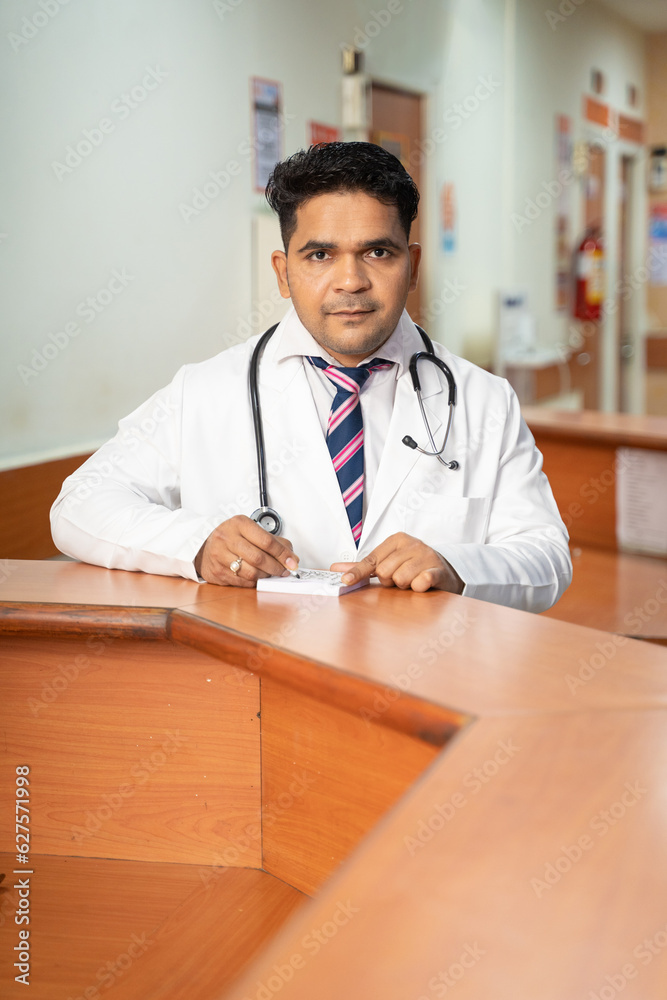 Doctor writing prescription with pen at desk. Doctor writing prescription with pen at desk.