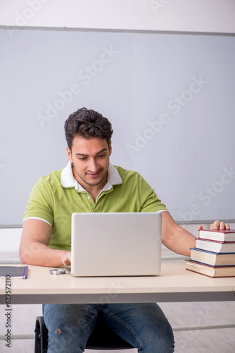 Young male student in telestudying concept