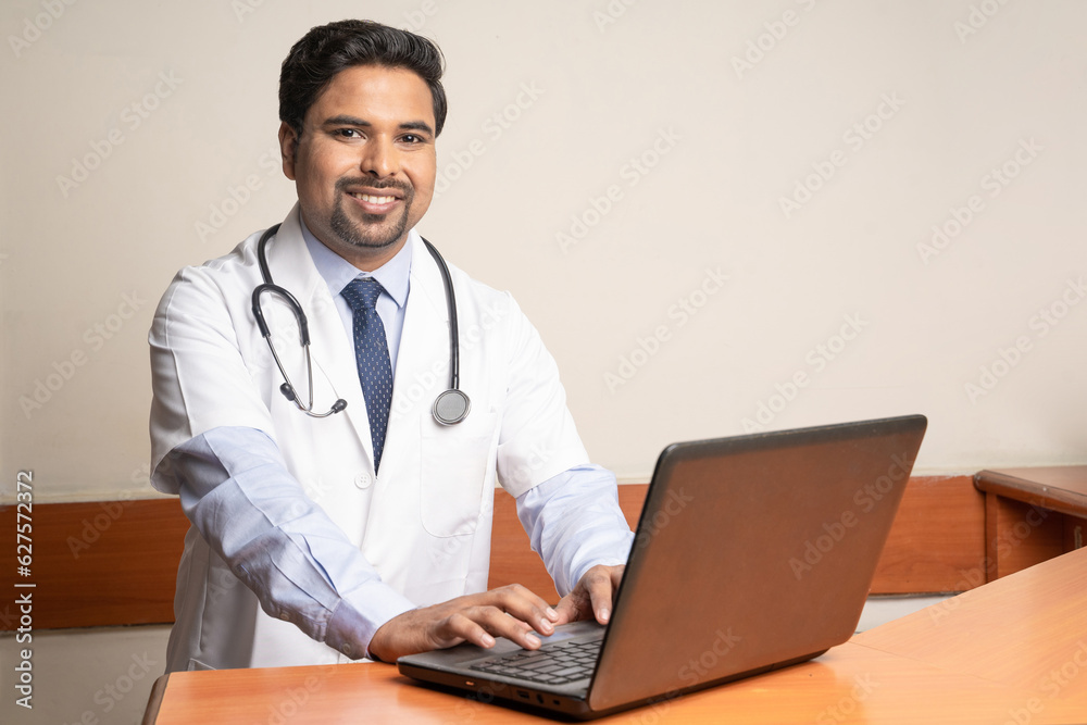 Doctor working on laptop in his medical office. Doctor working on laptop in his medical office.