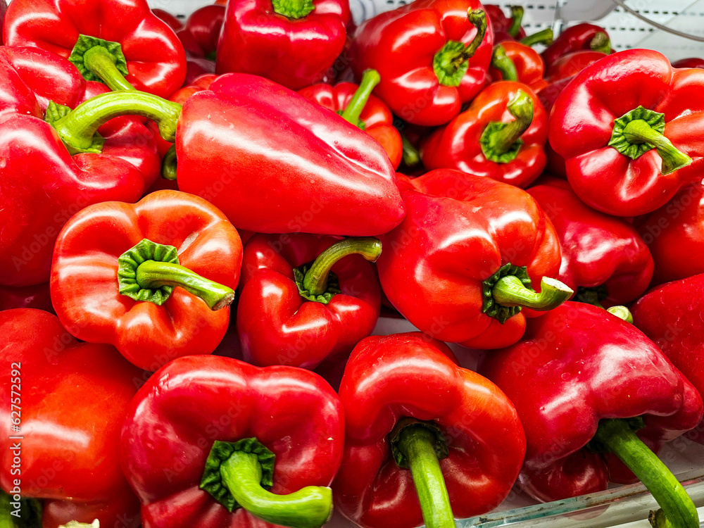 Pile of Red bell peppers in a supermarket local market, Bunch of organic red peppers. Fresh ripe red peppers	