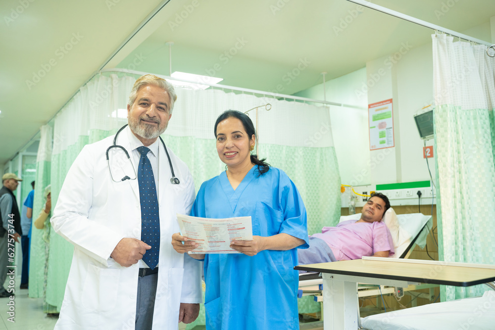 Senior doctor discussing with female assistant after checking patient at hospital Senior doctor discussing with female assistant after checking patient at hospital