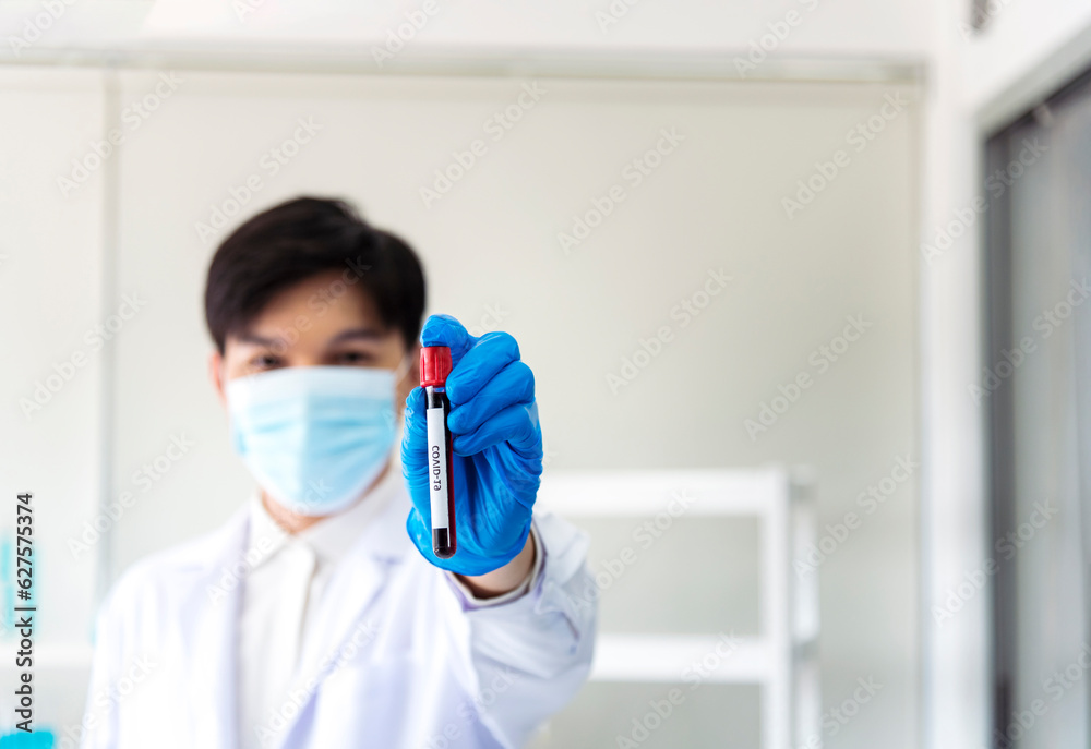 Scientist man holding sample blood test tube in science laboratory. Doctor clinic healthcare technician lab testing blood sample diagnosis. Asian man scientist working in hiv testing medical lab. Scientist man holding sample blood test tube in science laboratory. Doctor clinic healthcare technician lab testing blood sample diagnosis. Asian man scientist working in hiv testing medical lab.