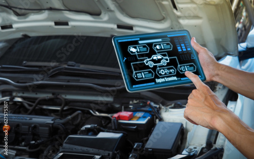 Smart Car Service Diagnostics Software concept.Mechanic using digital tablet Inspecting the Vehicle