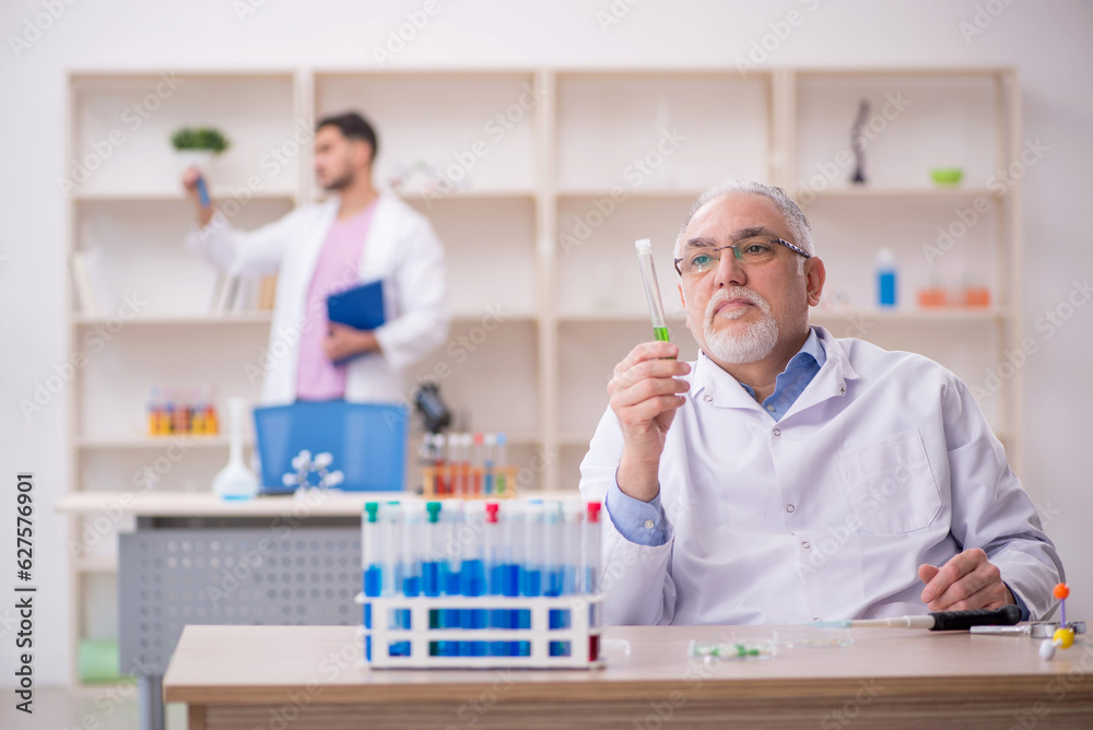 Two male chemists working at the lab Two male chemists working at the lab