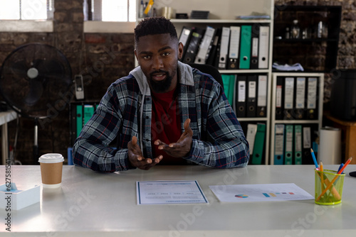 African american businessman sitting at desk, having video call and talking in office © WavebreakMediaMicro