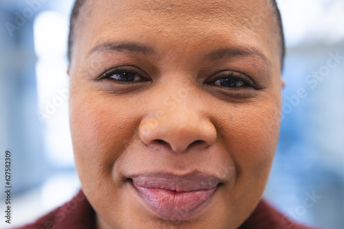 Portrait of happy african american female patient in waiting room at hospital