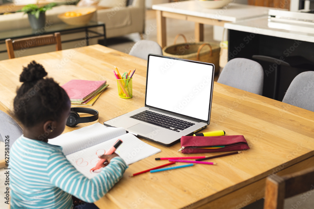 African american girl sitting at table using laptop with copy space for online lesson African american girl sitting at table using laptop with copy space for online lesson